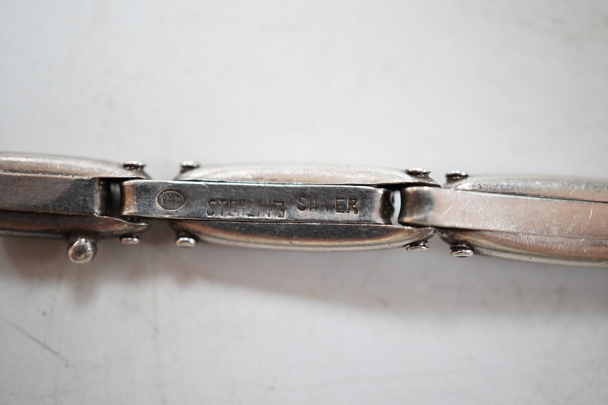 A lady's early 20th century continental sterling and enamel octagonal manual wind wrist watch, on a sterling expanding bracelet, 16.8cm. Condition - poor to fair